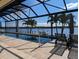 Stunning waterfront pool with a screened enclosure, sun loungers, and a private dock, perfect for relaxation at 3572 Peace River Dr, Punta Gorda, FL 33983