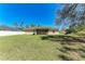 Expansive backyard view highlighting the property's generous lawn, exterior facade, and privacy fence at 3749 Albatros Ln, North Port, FL 34288