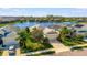 Aerial view of a beautiful single-Gathering home with lake view and well-manicured lawn at 3838 Manorwood Loop, Parrish, FL 34219