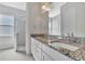 Bathroom featuring granite countertops, dual sinks, glass-enclosed shower and tile flooring at 3838 Manorwood Loop, Parrish, FL 34219