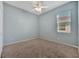 Bedroom with large window providing natural light and a ceiling fan at 3838 Manorwood Loop, Parrish, FL 34219