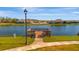 Wooden fishing pier extending over a community lake, offering peaceful recreation and scenic views at 3838 Manorwood Loop, Parrish, FL 34219