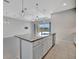 Open-concept kitchen featuring granite countertops, a large island, and views to the water at 3838 Manorwood Loop, Parrish, FL 34219