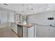 This spacious kitchen features an island with granite countertop, stainless steel appliances, and open floorplan at 3838 Manorwood Loop, Parrish, FL 34219