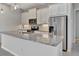 Modern kitchen featuring granite countertops, stainless steel appliances, and pendant lighting at 3838 Manorwood Loop, Parrish, FL 34219