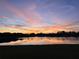 Sunset view of the lake at the end of the day paints the water with vibrant colors at 3838 Manorwood Loop, Parrish, FL 34219