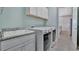 Laundry room featuring washer, dryer, sink, and storage at 3838 Manorwood Loop, Parrish, FL 34219