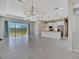 Bright open-concept living area with large windows overlooking a scenic waterfront view at 3838 Manorwood Loop, Parrish, FL 34219
