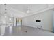 Spacious living room with neutral tones, stylish lighting, and a large window for natural light at 3838 Manorwood Loop, Parrish, FL 34219