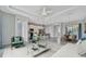 Bright, open living room with modern furnishings, and a view into the kitchen area at 3838 Manorwood Loop, Parrish, FL 34219