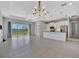 Bright open-concept living area with large windows overlooking a scenic waterfront view at 3838 Manorwood Loop, Parrish, FL 34219