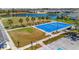 Aerial shot of a blue sports court for community recreation next to a beautiful lake and homes at 3838 Manorwood Loop, Parrish, FL 34219