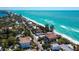 Aerial view of oceanfront homes along the beach with clear blue water at 3909 Casey Key Rd, Nokomis, FL 34275