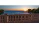 Balcony stone railing showing oceanfront view as the sun sets at 3909 Casey Key Rd, Nokomis, FL 34275