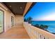 Spacious balcony overlooking the water view, with white stone railing and tile floor at 3909 Casey Key Rd, Nokomis, FL 34275