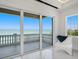 Enjoy ocean views from the balcony through large sliding glass doors at 3909 Casey Key Rd, Nokomis, FL 34275