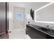 Sleek bathroom featuring a modern vanity with an illuminated mirror, walk-in shower, and contemporary fixtures at 3909 Casey Key Rd, Nokomis, FL 34275