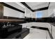 Modern bathroom with black and white striped walls, glass-enclosed shower, and sleek black vanity at 3909 Casey Key Rd, Nokomis, FL 34275