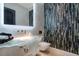 Modern bathroom with a unique glass sink and vanity, and colorful vertical tile accent wall at 3909 Casey Key Rd, Nokomis, FL 34275