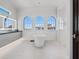 Bright bathroom features a modern soaking tub under arched windows and sleek vanity at 3909 Casey Key Rd, Nokomis, FL 34275