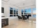 Bright dining area with modern chandelier, ocean views, and seating for six around glass table at 3909 Casey Key Rd, Nokomis, FL 34275