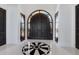 Welcoming foyer featuring high ceilings, a striking decorative floor design, and a grand arched doorway at 3909 Casey Key Rd, Nokomis, FL 34275