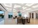Spacious living room boasting contemporary lighting, a fireplace, and glass doors leading to an outdoor area at 3909 Casey Key Rd, Nokomis, FL 34275