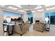 Bright living room with stylish furnishings, modern lighting, and expansive windows showcasing ocean views at 3909 Casey Key Rd, Nokomis, FL 34275