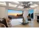 Bright living room with tile flooring, decorative lighting, and expansive sliding doors showcasing ocean views at 3909 Casey Key Rd, Nokomis, FL 34275