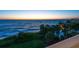 Ocean view with tropical vegetation, and landscape from the property overlooking the calming sunset at 3909 Casey Key Rd, Nokomis, FL 34275