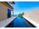 Beautiful pool with an ocean view, patio, and privacy wall at 3909 Casey Key Rd, Nokomis, FL 34275