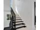 Beautiful staircase with modern design and lighting, leading to the next level at 3909 Casey Key Rd, Nokomis, FL 34275