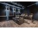 Home theater room with tiered seating, black leather recliners, and carpet at 3909 Casey Key Rd, Nokomis, FL 34275