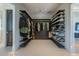 Organized walk-in closet with custom shelving, cabinets, and plenty of storage space for clothing and accessories at 3909 Casey Key Rd, Nokomis, FL 34275