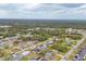Aerial view of houses in the neighborhood near a shopping area and wooded area at 392 Yeager St, Port Charlotte, FL 33954