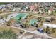 Aerial view of a park with a playground, basketball court, and tennis court at 392 Yeager St, Port Charlotte, FL 33954