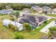Aerial view of a home with a pool, screen enclosure and solar panels on the roof at 392 Yeager St, Port Charlotte, FL 33954