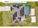 Aerial view showcases a home with solar panels, pool, outdoor area and well-maintained lawn at 392 Yeager St, Port Charlotte, FL 33954
