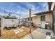 Backyard with a white privacy fence, jacuzzi, grill, and landscaping at 392 Yeager St, Port Charlotte, FL 33954