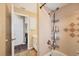 Well-lit bathroom with a shower and tub combo with a hand-held shower head and storage racks at 392 Yeager St, Port Charlotte, FL 33954