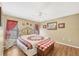 Inviting bedroom with hardwood floors, a quilt bedspread, and decorative curtains at 392 Yeager St, Port Charlotte, FL 33954