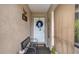 Cozy entryway featuring a bench, welcome mat, and decorative wreath on a white door at 392 Yeager St, Port Charlotte, FL 33954