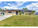 Lovely single-story home with solar panels, a well-manicured lawn, and charming curb appeal at 392 Yeager St, Port Charlotte, FL 33954