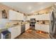 Bright kitchen featuring white cabinets, stainless steel appliances, and hardwood floors at 392 Yeager St, Port Charlotte, FL 33954