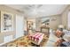 Cozy living room with patterned rug, neutral walls, and view into the kitchen with stainless steel appliances at 392 Yeager St, Port Charlotte, FL 33954