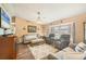Inviting living room featuring a fireplace, plush seating, and a large window at 392 Yeager St, Port Charlotte, FL 33954