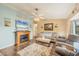 Comfortable living room with fireplace, ceiling fan, and neutral tones at 392 Yeager St, Port Charlotte, FL 33954