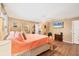 Open main bedroom with wood floors, a large bed, and a view into the walk-in closet at 392 Yeager St, Port Charlotte, FL 33954