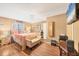 Spacious main bedroom with hardwood floors, a seating bench, and a mounted television at 392 Yeager St, Port Charlotte, FL 33954