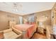 Comfortable main bedroom featuring hardwood floors, a wooden bed frame, and soft natural light at 392 Yeager St, Port Charlotte, FL 33954